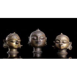 THREE BRONZE HEADS OF FEMALE DEITIES