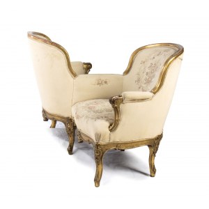 French gilt Napoleon III tete-a-tète sofa - second half 19th century, of Parisian manufacture with a gilded frame. This type of sofa, consisting of two seats separated by a small console or armrest, allowed them to be positioned opposite each other to cre