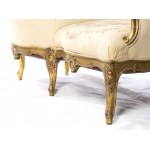 French gilt Napoleon III tete-a-tète sofa - second half 19th century, of Parisian manufacture with a gilded frame. This type of sofa, consisting of two seats separated by a small console or armrest, allowed them to be positioned opposite each other to cre