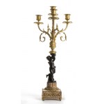French gilded bronze triptych - Paris 19th century, signed H. JURNET & CIE., A pair of square marble and gilt bronze candelabra resting on spinning top feet, patinated bronze shafts depicting two putti supporting the upper five flames Clock with rectangul