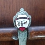 Set of collectible spoons in a wooden display case