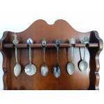 Set of collectible spoons in a wooden display case