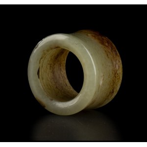 A GREEN AND RUSSET JADE ARCHER'S RING China, 20th century