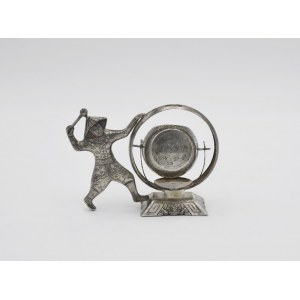 Tea strainer in the form of a character beating a drum
