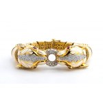 DAVID WEBB: flexible gold bracelet with pair of tiger heads, white enamel, rubies and diamonds