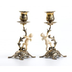 A pair of silver and ivory candlesticks