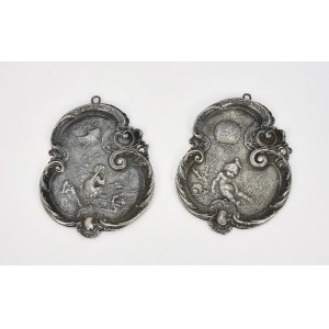 A pair of decorative badges with small children in rococo style
