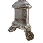 Wooden torchiere with silver leaf finishes supported by three lion paw-shaped feet