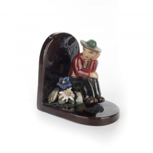 A polychrome ceramic bookend