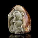 A PALE GREEN JADE PEBBLE WITH A CARVED DRAGON