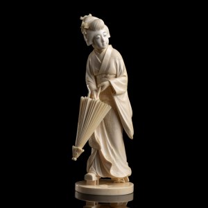 AN IVORY OKIMONO WITH GEISHA