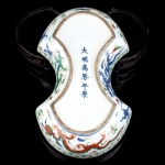 AN INGOT-SHAPED WUCAI ENAMELLED PORCELAIN 'DRAGONS' BOX AND COVER