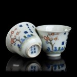 TWO POLYCHROME ENAMELLED PORCELAIN CUPS