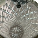 Glass vase crafted and finished with a silver-plated metal rim at the top