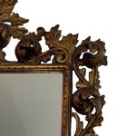 Carved and gilded wooden mirror with floral motif