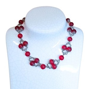 Necklace of red beads in a decorative setting