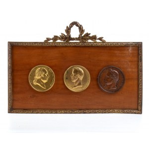 Three bronze medallions in a frame