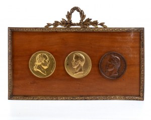 Three bronze medallions in a frame