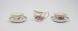 NYMPHENBURG, Pair of mocha cups and creamer in floral motifs