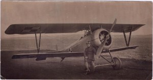 Photograph of an aviator with a Nieuport model 24 or 29 aircraft