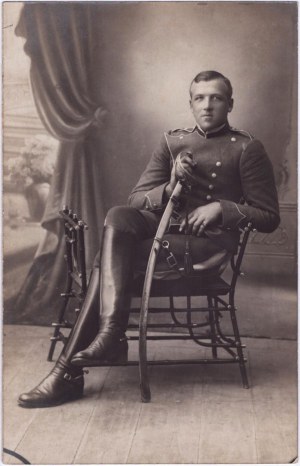 Portrétna fotografia sediaceho dôstojníka v uniforme so šabľou