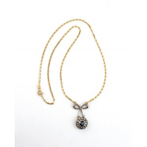 Gold necklace with gold and silver pendant with a sapphire and diamonds