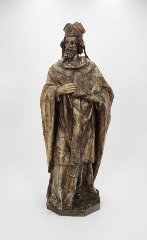 A statue of a bishop with a book