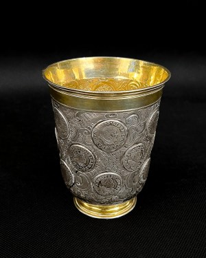 Silver mug with coins