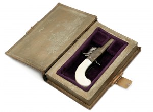 Miniature of a percussion pistol stored in a box in the form of a book