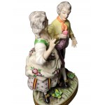 MEISSEN, Man and woman on oval base on grass