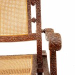 Armchair in wood carved with floral motifs