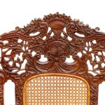 Armchair in wood carved with floral motifs