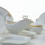 Lot of nine serving pieces in white porcelain with pure gold finish