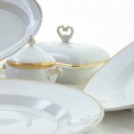 Lot of nine serving pieces in white porcelain with pure gold finish
