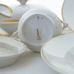 Lot of nine serving pieces in white porcelain with pure gold finish