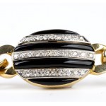 Long gold necklace with black enamel and diamonds