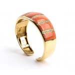 A gold open bangle bracelet featuring an elegant blend of coral and diamonds