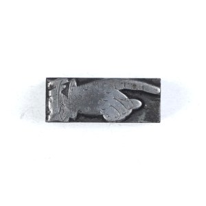 Rączka. Klisza form. 3,4x1,3 cm na podstawie metalowej.