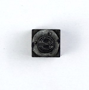The name of the printing house of Antoni Kozianski. Plate form. 1.5x1.5 cm on a wooden base.