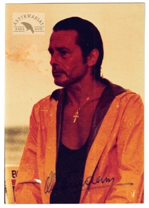 [DELON Alain]. Alain Delon's signature on a color photograph.