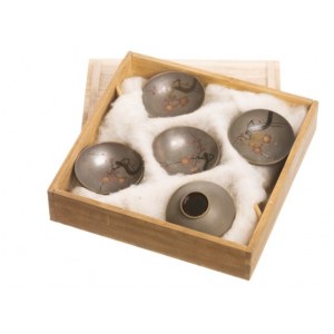 A set of five wooden skulls with a sakura motif