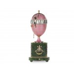 A magnificent clock in the shape of an egg, in the style of Carl Fabergé