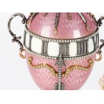A magnificent clock in the shape of an egg, in the style of Carl Fabergé