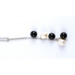 Gold necklace with diamond bar, onyx fringe and freshwater pearls.