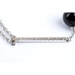 Gold necklace with diamond bar, onyx fringe and freshwater pearls.