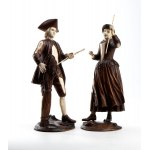 A pair of wood and bone carvings