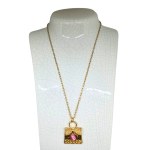 An elegant necklace with a pink stone