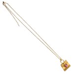 An elegant necklace with a pink stone