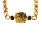 A solid, gold-plated necklace in an antique style with blue crystals