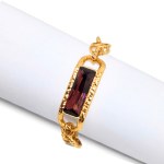Gold-plated bracelet with a striking burgundy Swarovski crystal
